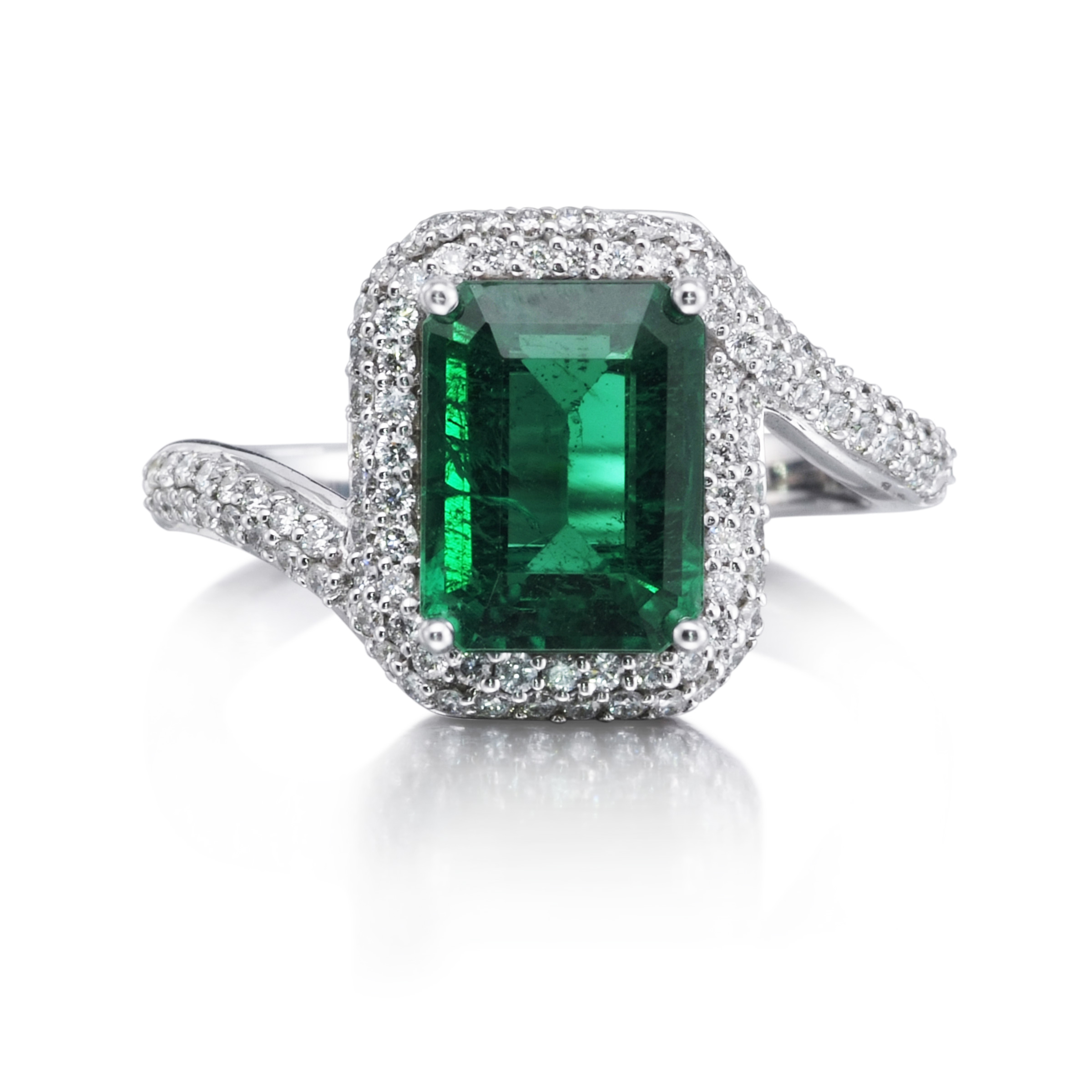 Emerald-cut emerald ring with a diamond halo and a bypass shank of pave diamonds