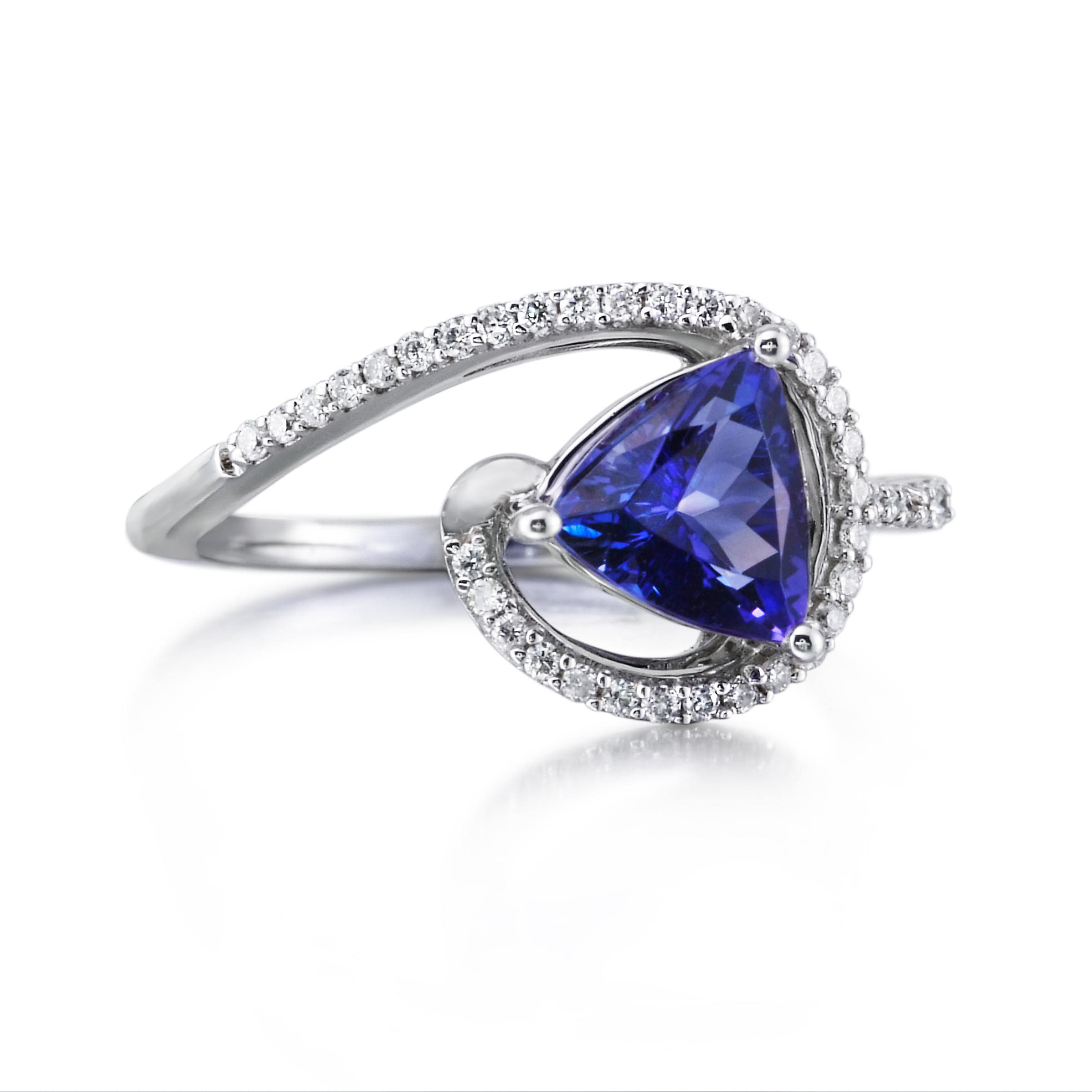 Trillion-cut tanzanite ring held by a sweeping diamond-set wave of white gold