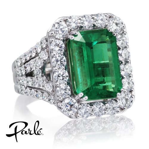 Parle emerald ring: an emerald-cut emerald in a diamond halo on a split diamond shank