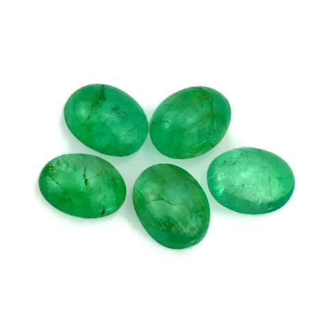 Five oval emerald cabochons arranged on a white background