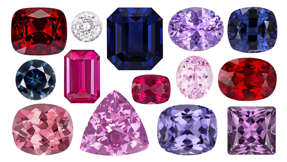 An assortment of spinels in many colours and cuts, from red and hot pink through lavender to deep blue