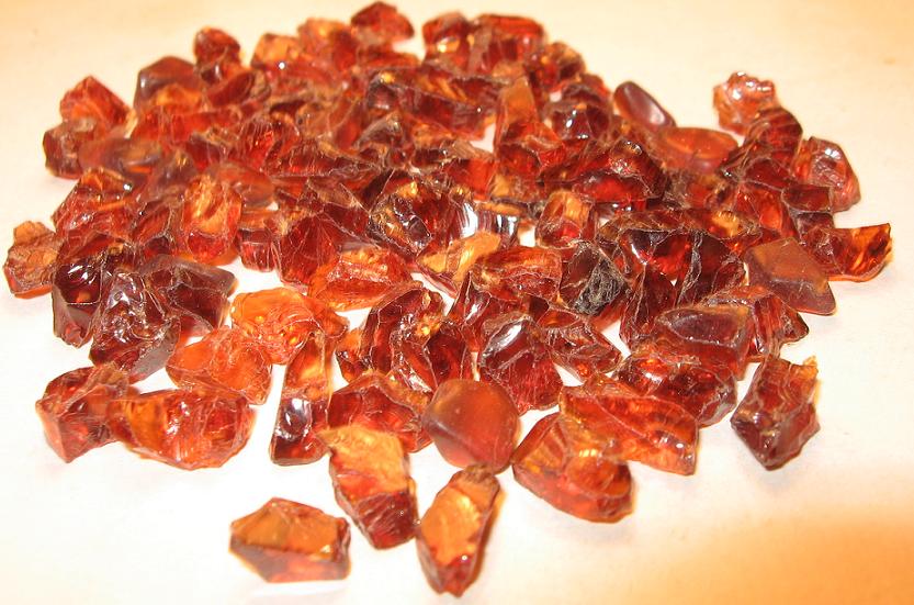 A heap of rough orange hessonite garnet crystals