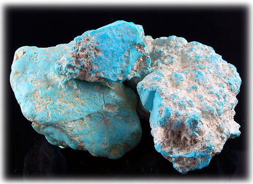 Two nuggets of rough Sleeping Beauty turquoise, evenly sky blue with brown host rock still attached