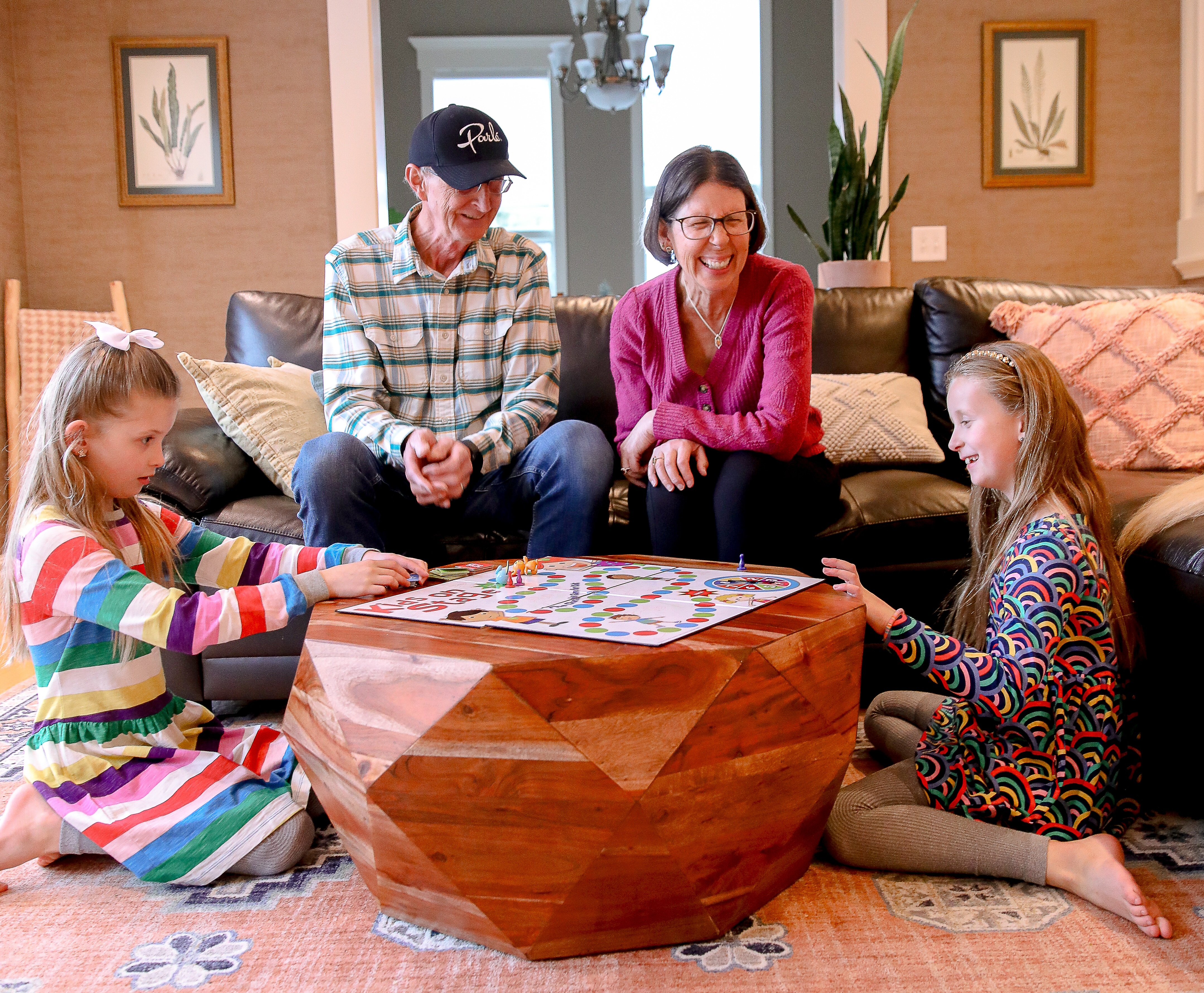 Frank and Sue playing a game with their grandkids